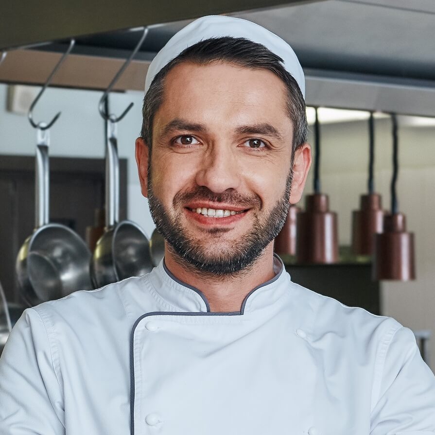 speak-with-the-taste-portrait-of-cheerful-chef-sta-UEFFCEM.jpg